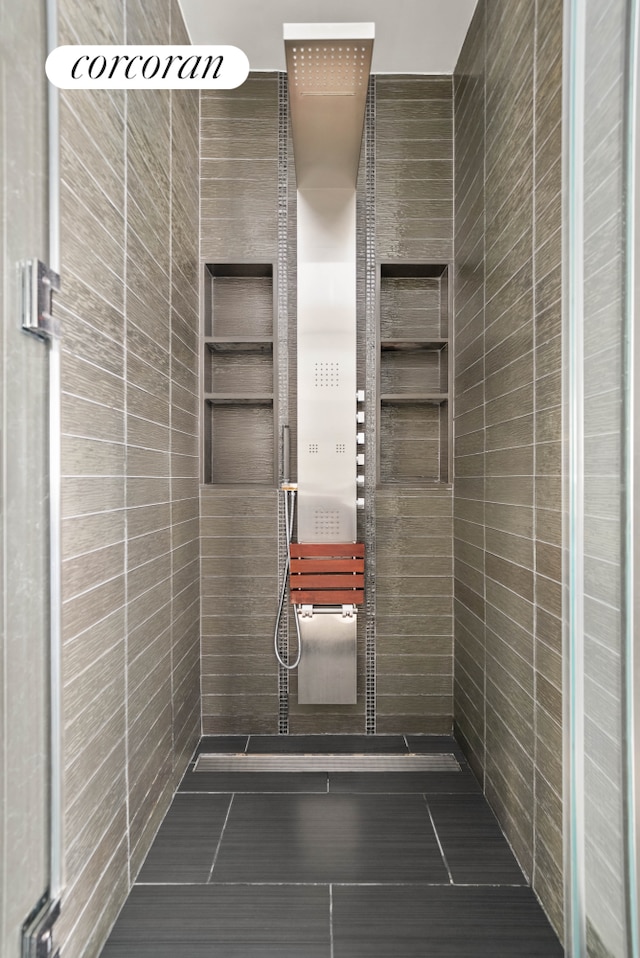 40 Broad St Unit Ph2Ce, New York City, NY 10004 - full bathroom with tiled shower, tile walls, and tile patterned flooring