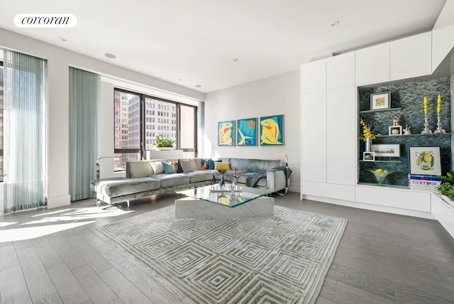 living area with wood finished floors and visible vents