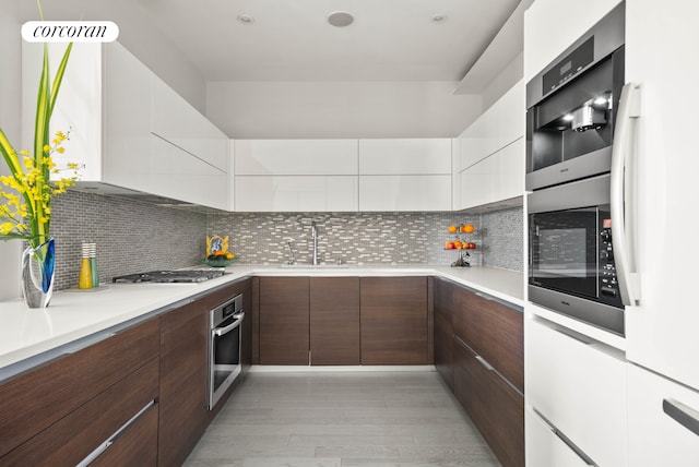 40 Broad St Unit Ph2Ce, New York City, NY 10004 - kitchen with modern cabinets, appliances with stainless steel finishes, white cabinetry, and light countertops