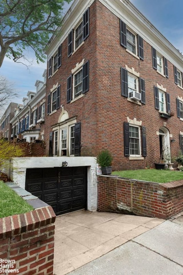 view of front of house featuring a garage, brick siding, and concrete driveway