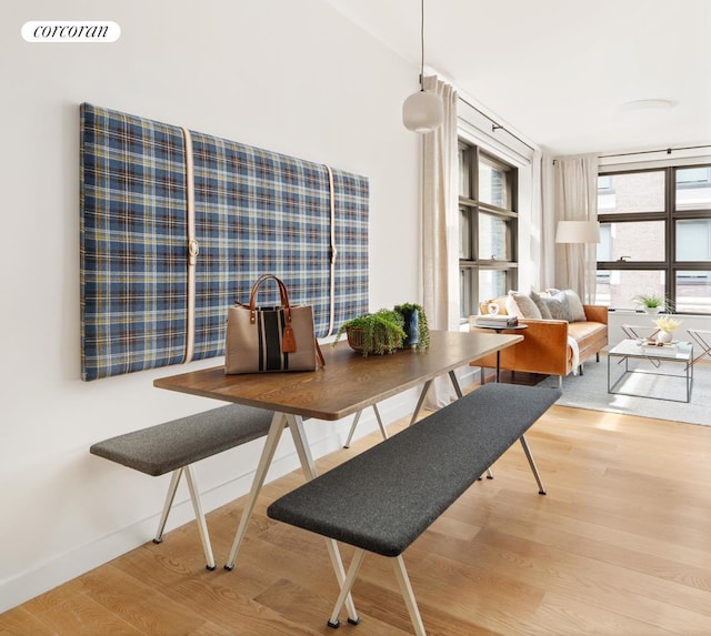 dining space with light wood-style floors, baseboards, and visible vents