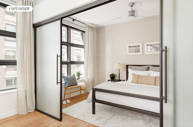 bedroom featuring light wood-style flooring and baseboards