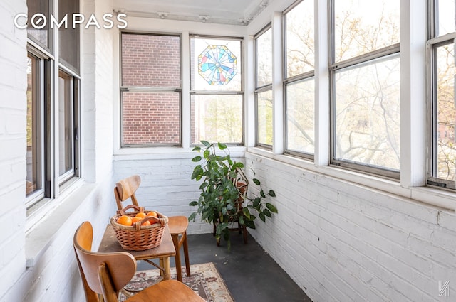 34-41 85th St Unit 4P, New York City, NY 11372 - sunroom featuring finished concrete floors, plenty of natural light, and brick wall