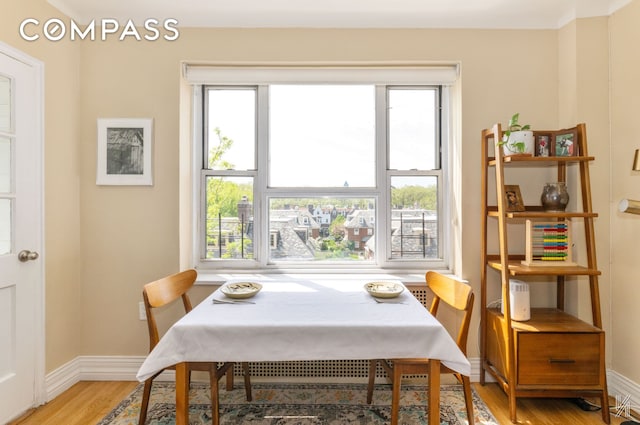 34-41 85th St Unit 4P, New York City, NY 11372 - dining space featuring light wood-type flooring and plenty of natural light