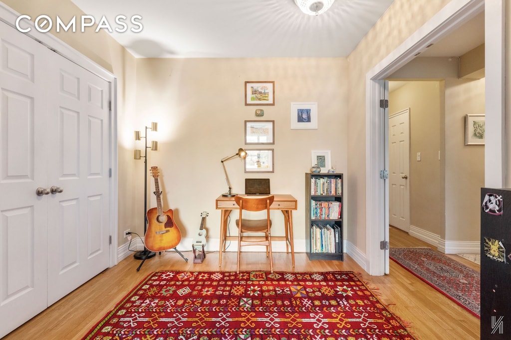 34-41 85th St Unit 4P, New York City, NY 11372 - living area with wood finished floors, baseboards, and a desk