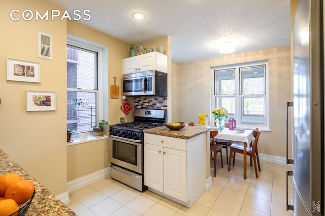 34-41 85th St Unit 4P, New York City, NY 11372 - kitchen featuring appliances with stainless steel finishes, white cabinetry, plenty of natural light, and recessed lighting