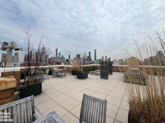 view of patio with a skyline view and outdoor dining space
