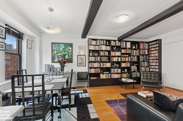 home office with beamed ceiling and wood finished floors