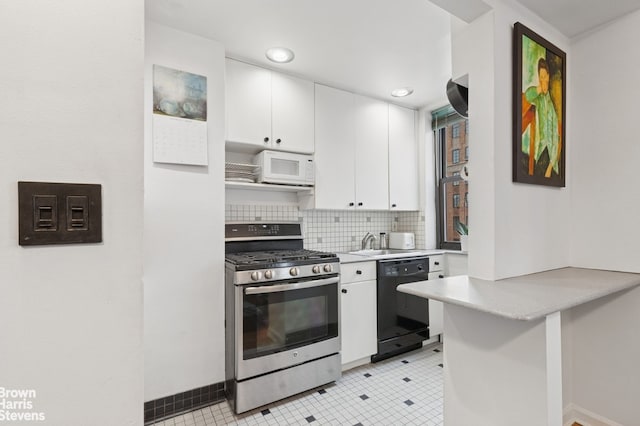 kitchen with gas range, dishwasher, white microwave, light countertops, and white cabinets