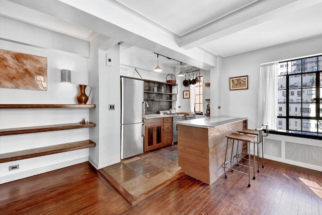 10 Park Ave Unit 12-K, New York City, NY 10016 - kitchen with stainless steel appliances, open shelves, a breakfast bar, baseboards, and beam ceiling