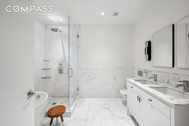 full bathroom featuring marble finish floors, a marble finish shower, recessed lighting, tile walls, and a soaking tub