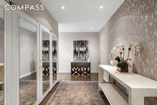 hallway with dark wood-style flooring, recessed lighting, baseboards, and french doors