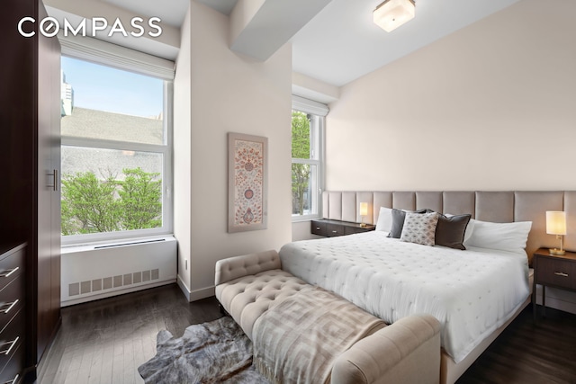 bedroom with hardwood / wood-style floors and baseboards