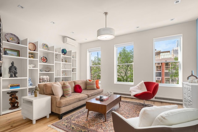 157 W 78th St Unit 6/5S, New York City, NY 10024 - sitting room with an AC wall unit, light wood-style flooring, and baseboards