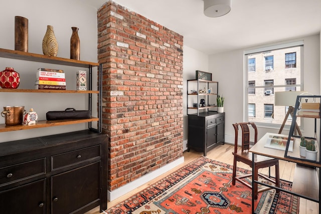 157 W 78th St Unit 6/5S, New York City, NY 10024 - office featuring brick wall, light wood-style flooring, and baseboards