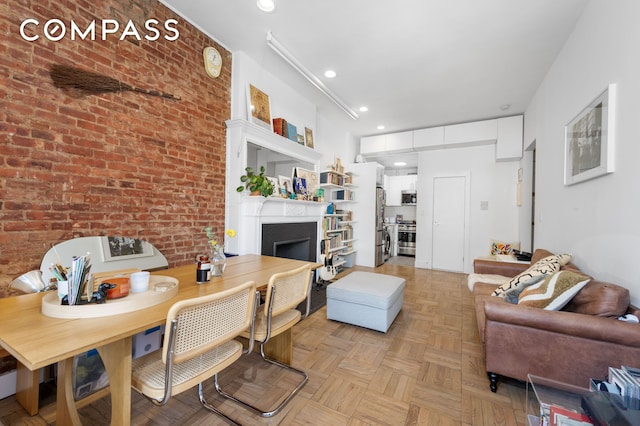 122 W 80th St Unit 3F, New York City, NY 10024 - living room featuring brick wall, a fireplace, and recessed lighting