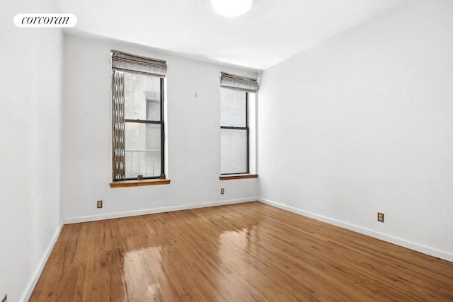 empty room with wood finished floors and baseboards