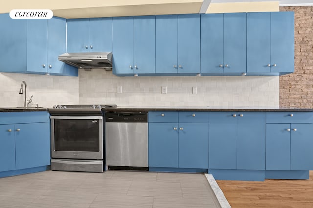 101 4th Ave Unit 2R, New York City, NY 11217 - kitchen featuring blue cabinets, appliances with stainless steel finishes, under cabinet range hood, and a sink