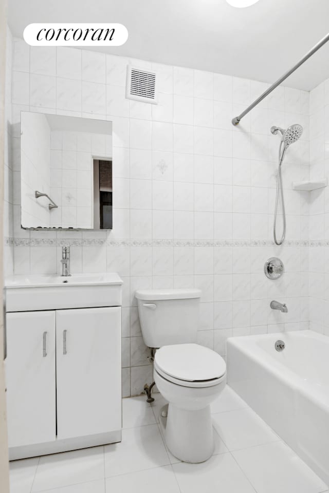 101 4th Ave Unit 2R, New York City, NY 11217 - full bathroom with toilet, vanity, bathtub / shower combination, tile walls, and tile patterned floors