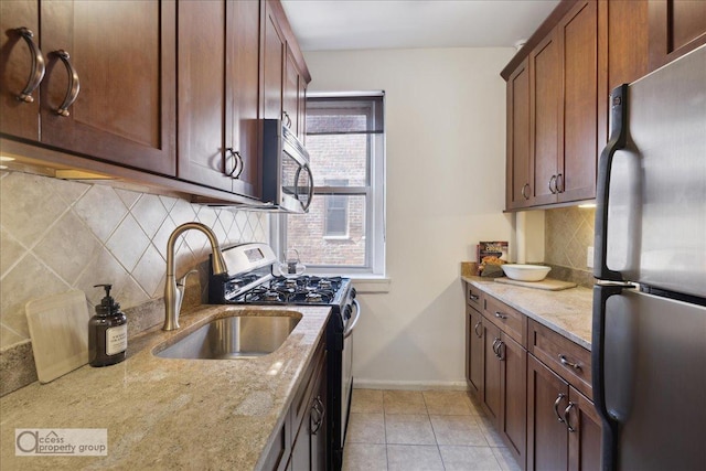 45 Park Ter W Unit 6E, New York City, NY 10034 - kitchen with appliances with stainless steel finishes, light stone countertops, tasteful backsplash, and a sink
