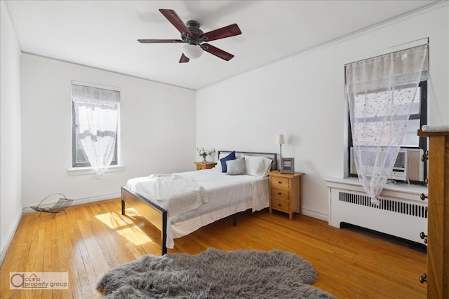 45 Park Ter W Unit 6E, New York City, NY 10034 - bedroom with radiator, wood finished floors, crown molding, a ceiling fan, and baseboards