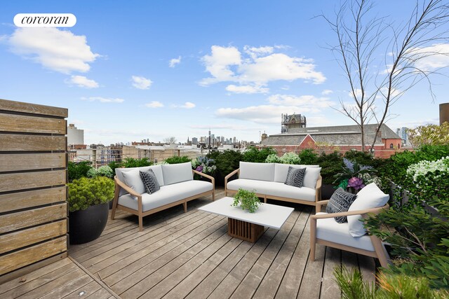 wooden deck with a view of city and an outdoor hangout area