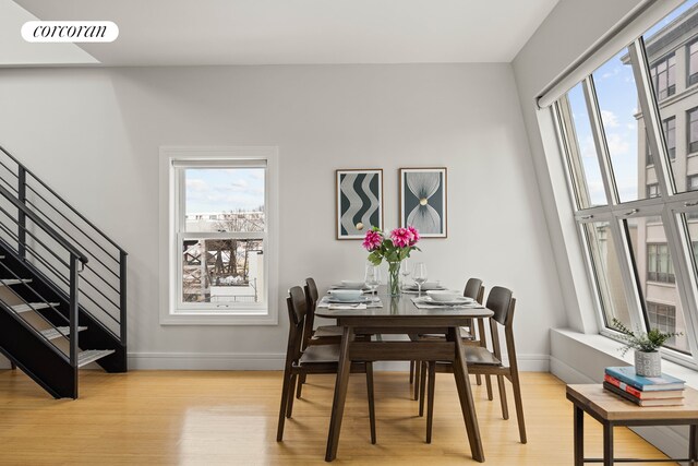 dining area featuring visible vents, baseboards, and light wood-type flooring