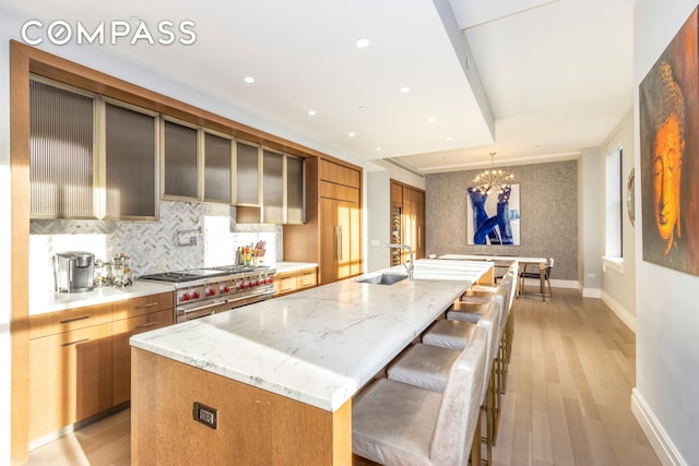 100 Barclay St Unit 15P, New York City, NY 10007 - kitchen with a sink, modern cabinets, double oven range, a large island with sink, and recessed lighting