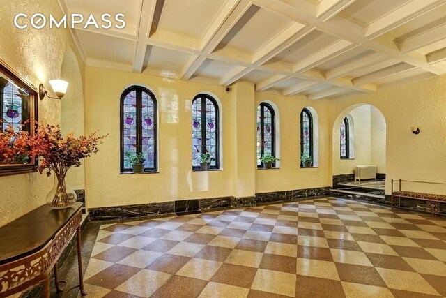 115 Cabrini Blvd Unit B51, New York City, NY 10033 - lobby featuring coffered ceiling, a textured wall, and beamed ceiling