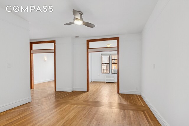 115 Cabrini Blvd Unit B51, New York City, NY 10033 - unfurnished room with a ceiling fan, light wood-style floors, and baseboards