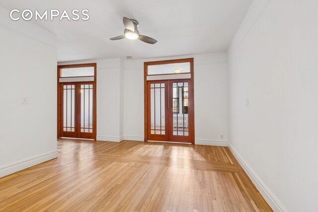 115 Cabrini Blvd Unit B51, New York City, NY 10033 - empty room with french doors, light wood finished floors, a ceiling fan, and baseboards