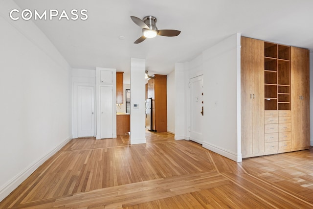 115 Cabrini Blvd Unit B51, New York City, NY 10033 - unfurnished bedroom with freestanding refrigerator, baseboards, parquet flooring, ensuite bathroom, and ceiling fan
