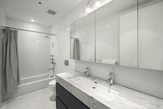 bathroom with toilet, backsplash, vanity, shower / bathtub combination with curtain, and visible vents