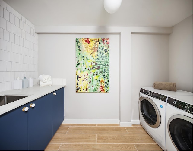 538 Henry St Unit 1, New York City, NY 11231 - washroom featuring washing machine and clothes dryer, light wood-type flooring, and cabinet space