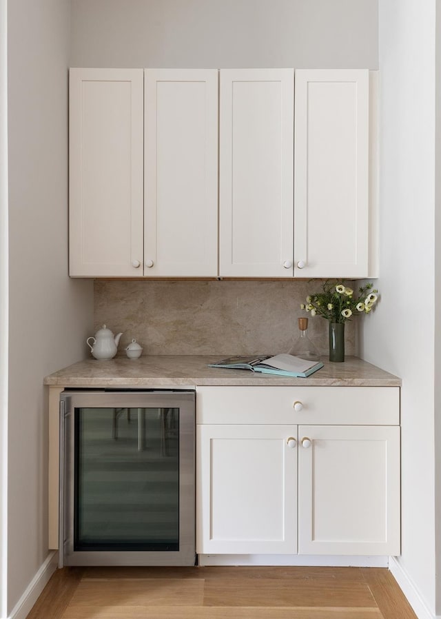 538 Henry St Unit 1, New York City, NY 11231 - bar area featuring beverage cooler, light wood-style floors, and decorative backsplash