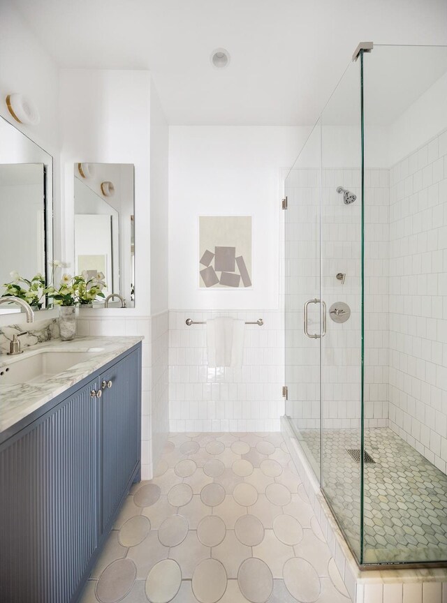 538 Henry St Unit 1, New York City, NY 11231 - full bath with a stall shower, tile walls, a wainscoted wall, vanity, and tile patterned flooring