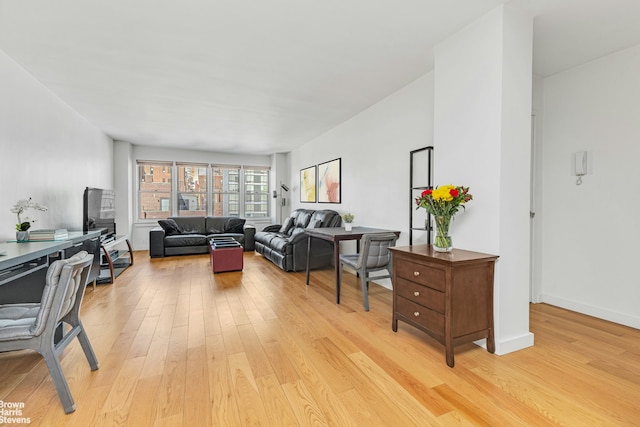 155 E 38th St Unit 16B, New York City, NY 10016 - living room featuring light wood-style floors and baseboards