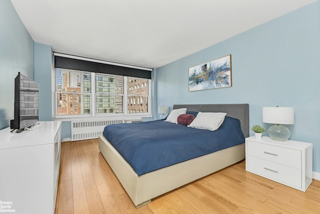 155 E 38th St Unit 16B, New York City, NY 10016 - bedroom with radiator and light wood-style flooring
