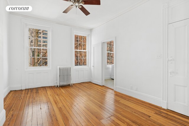 43 Charlton St, New York City, NY 10014 - unfurnished room with radiator, baseboards, visible vents, light wood-style floors, and a ceiling fan