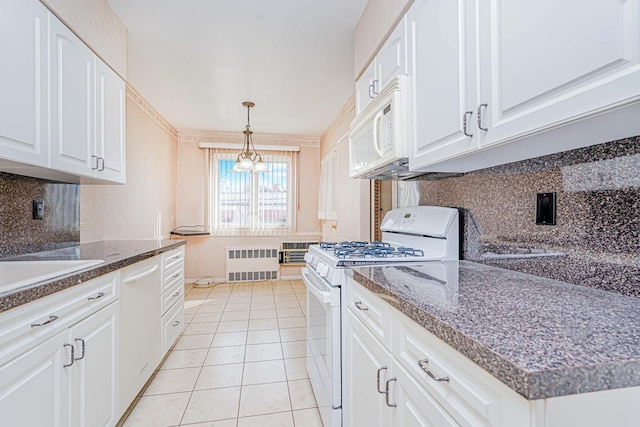 kitchen featuring white appliances, radiator, decorative backsplash, and white cabinets