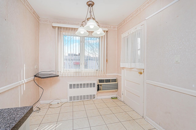 unfurnished dining area featuring radiator heating unit, heating unit, and light tile patterned floors