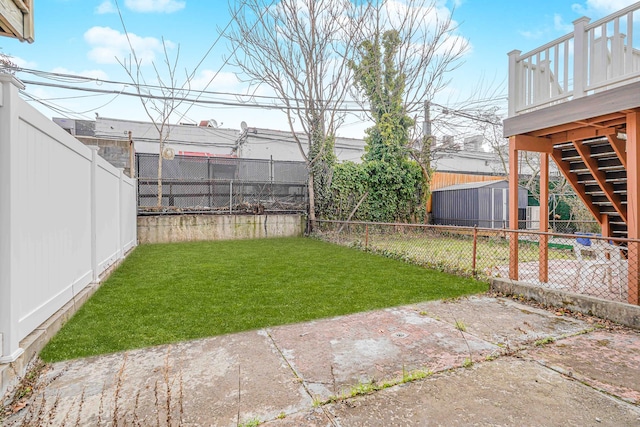 view of yard featuring stairs, a deck, and a patio