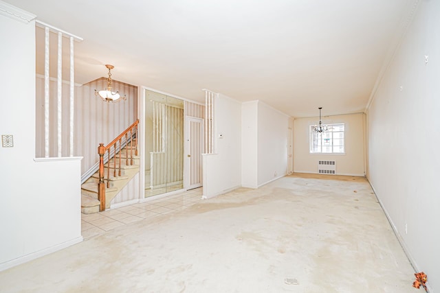 empty room featuring a chandelier, radiator heating unit, stairs, and baseboards