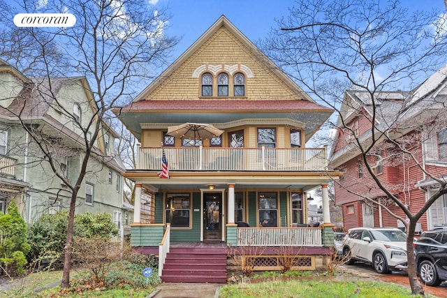 victorian home featuring a porch and a balcony