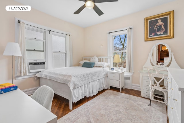 bedroom featuring baseboards, a ceiling fan, wood finished floors, and cooling unit
