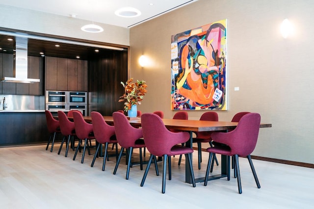 dining space featuring light wood-style flooring