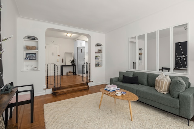 210 W 103rd St Unit 2G, New York City, NY 10025 - living room featuring arched walkways, built in shelves, and baseboards