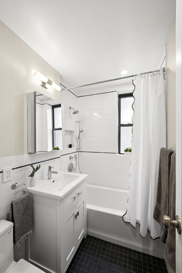 210 W 103rd St Unit 2G, New York City, NY 10025 - bathroom featuring vanity, tile patterned flooring, shower / bathtub combination with curtain, toilet, and tile walls
