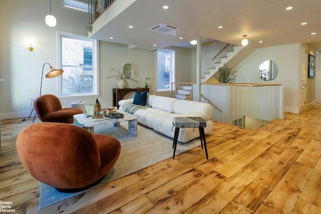 interior space featuring baseboards, wood finished floors, visible vents, and recessed lighting