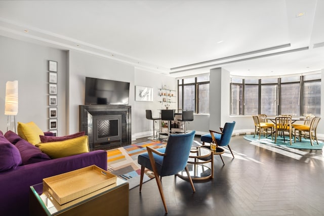 living room with a fireplace with flush hearth, baseboards, and recessed lighting